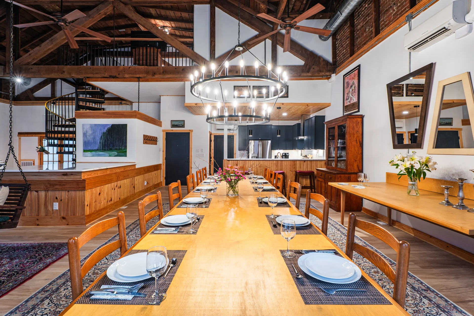 Grand 14-person dining table beneath wooden rafters